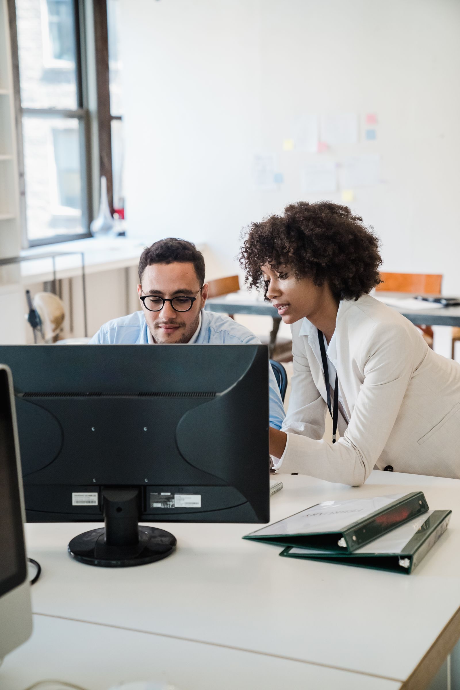 Two colleagues working through the dashboard together at a desktop computer